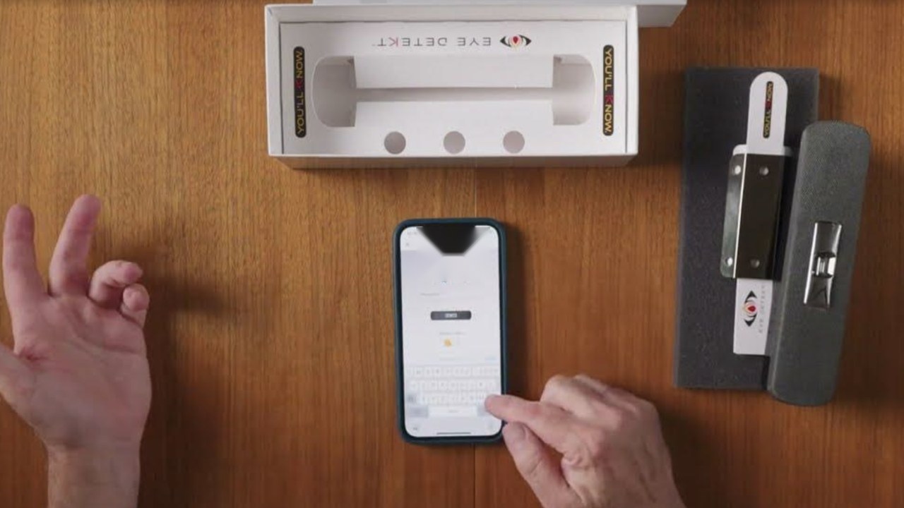 Hands setting up The Flame Detector with a phone app
